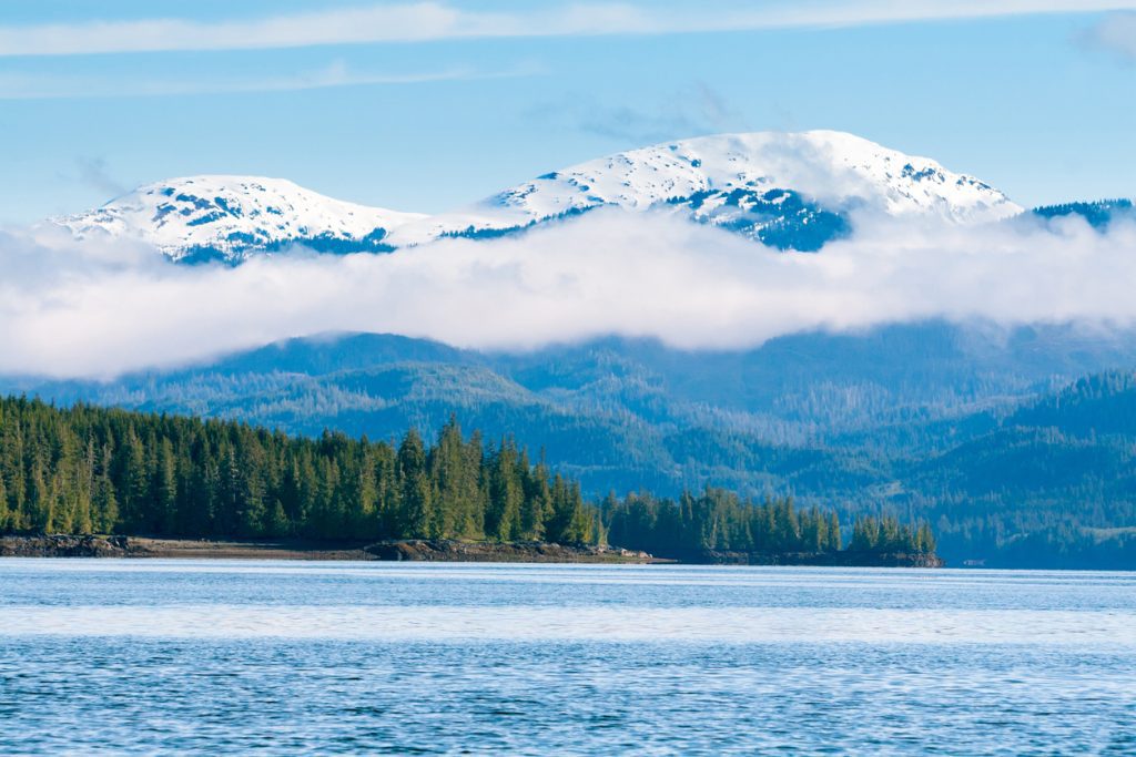 Low-hanging clouds over mountains and forest near Ketchikan, Alaska - Viking Travel